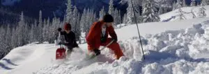 Two people practicing avalanche skills