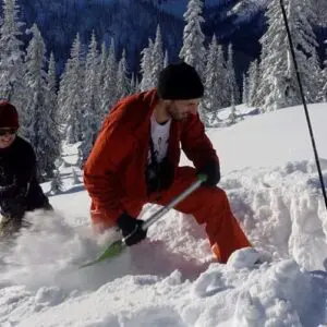 Two people practicing avalanche skills