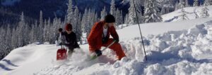 Two people practicing avalanche skills