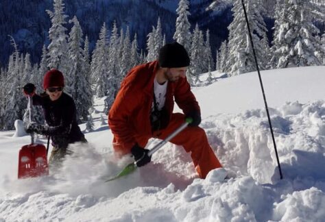 Two people practicing avalanche skills